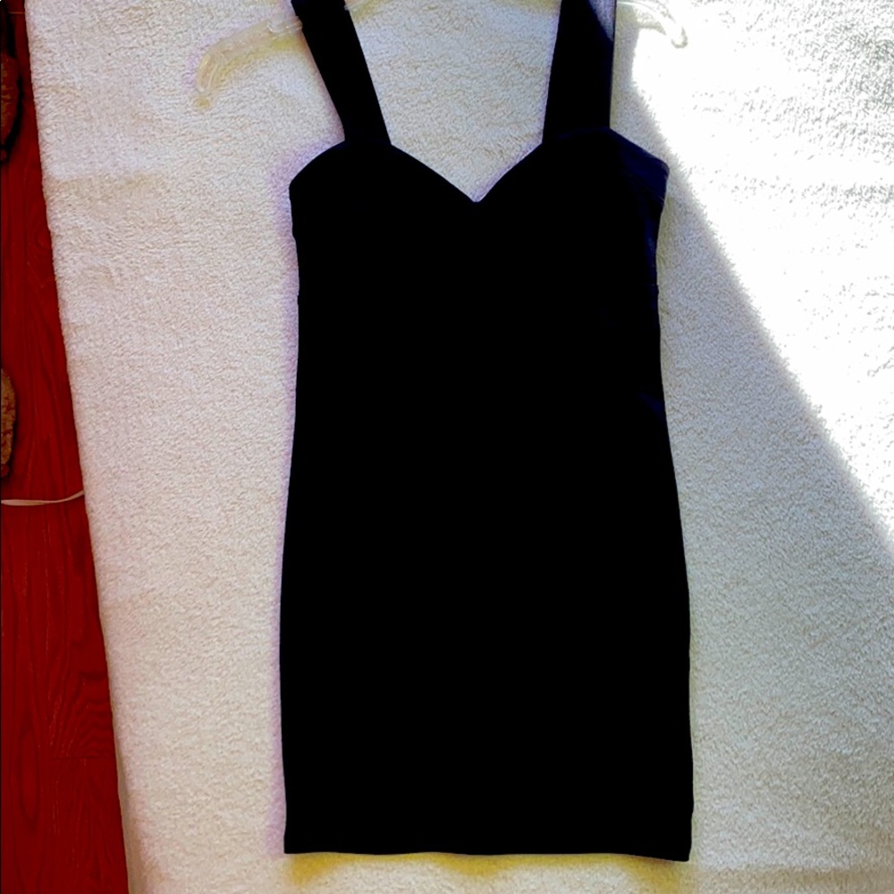 A black, heart shaped breast outline, tight dress